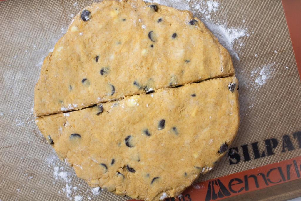 A scone dough is cut in half.