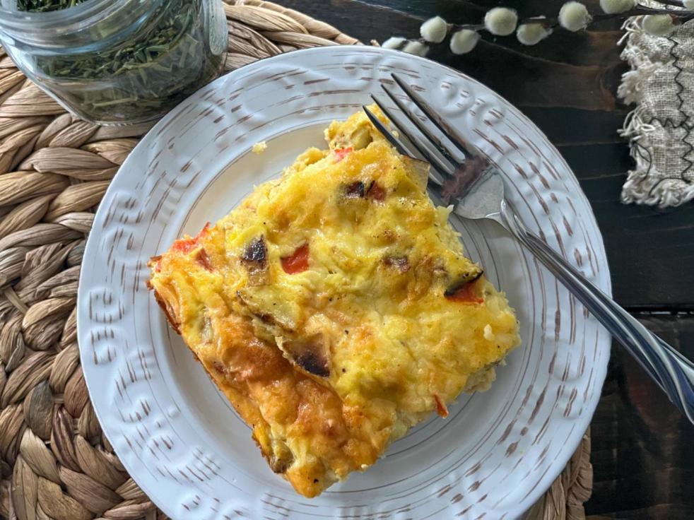 Vegetarian Breakfast Egg Casserole is sliced and served on a saucer.
