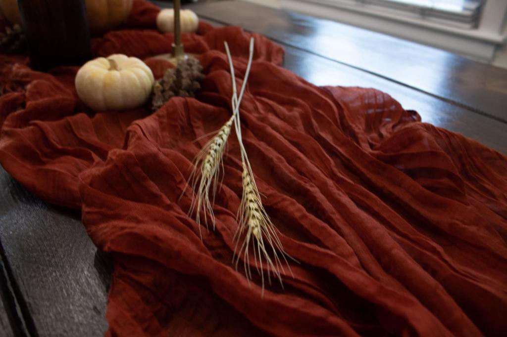 Dried wheatgrass is added to a table setting for a bit of texture.
