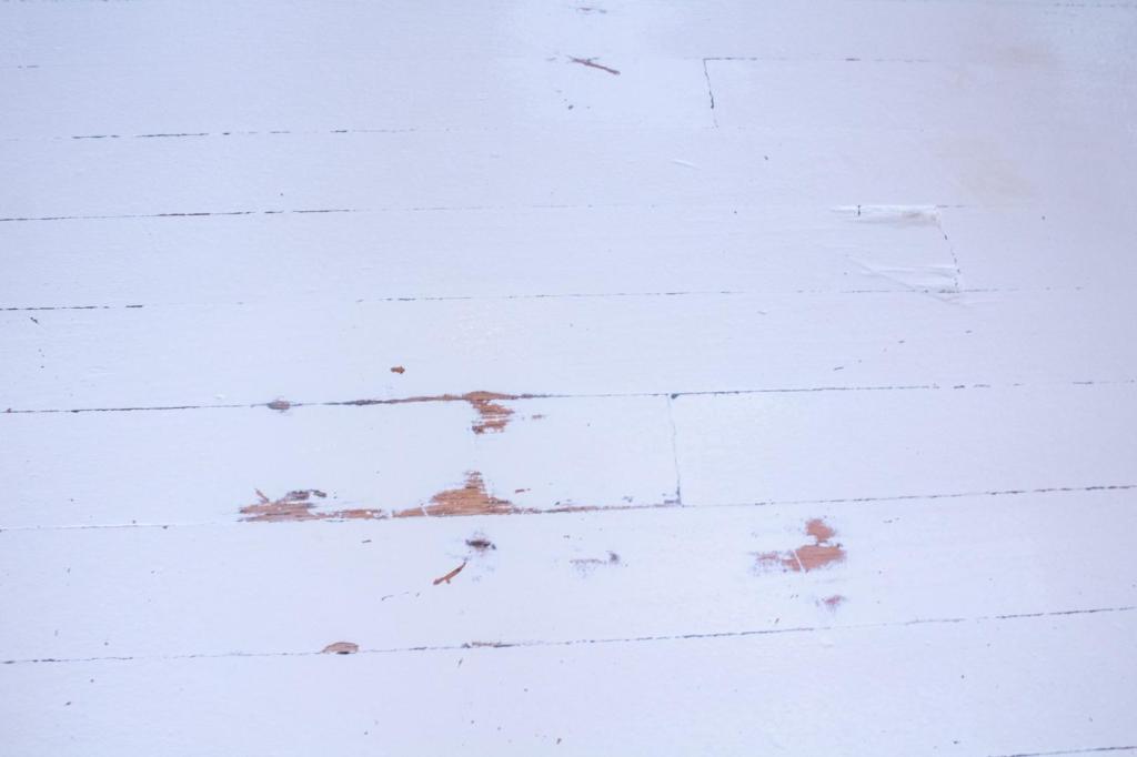 A scratched and scuffed up floor is ready to be repainted.