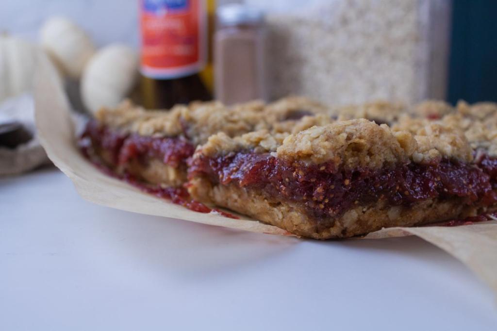 A jam layer is evident in this side view of a breakfast bars recipe with jam.