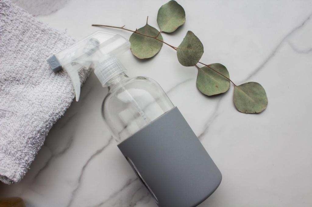 A homemade all-purpose cleaner is shown in a glass bottle.