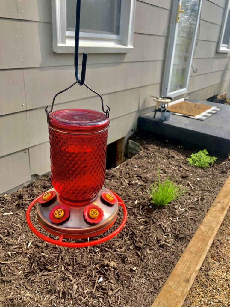 A hummingbird feeder is a practical piece of spring patio decor to add this sprig season.