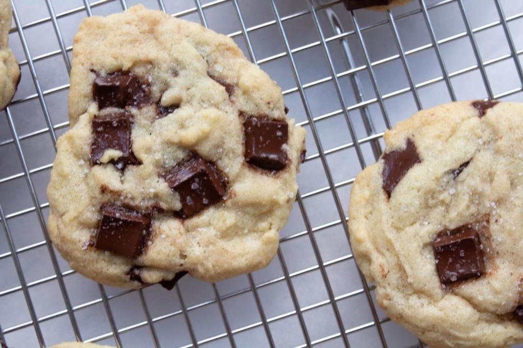 Cookies are shown in a close-up shot with melted chocolate chunks.