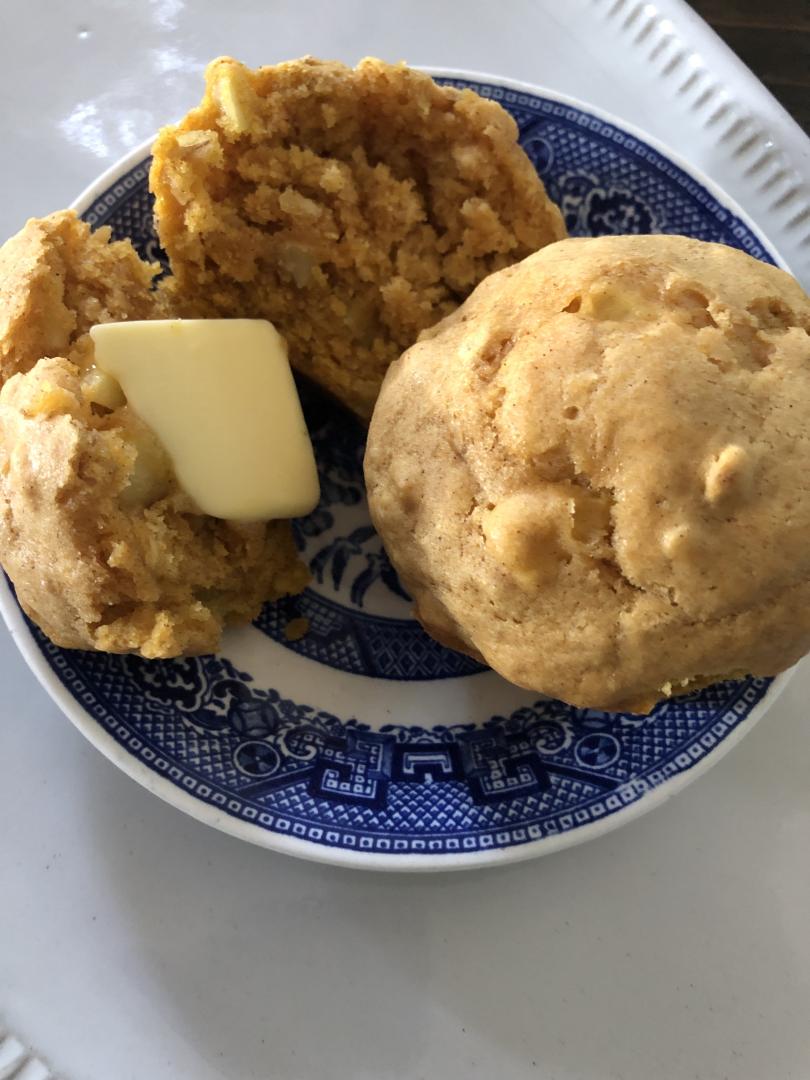 A fall muffin recipe sits atop antique china with melted butter on them.