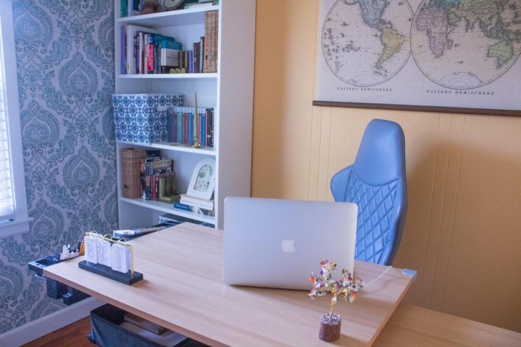 A creative desk is being used for professional work in a boho office.