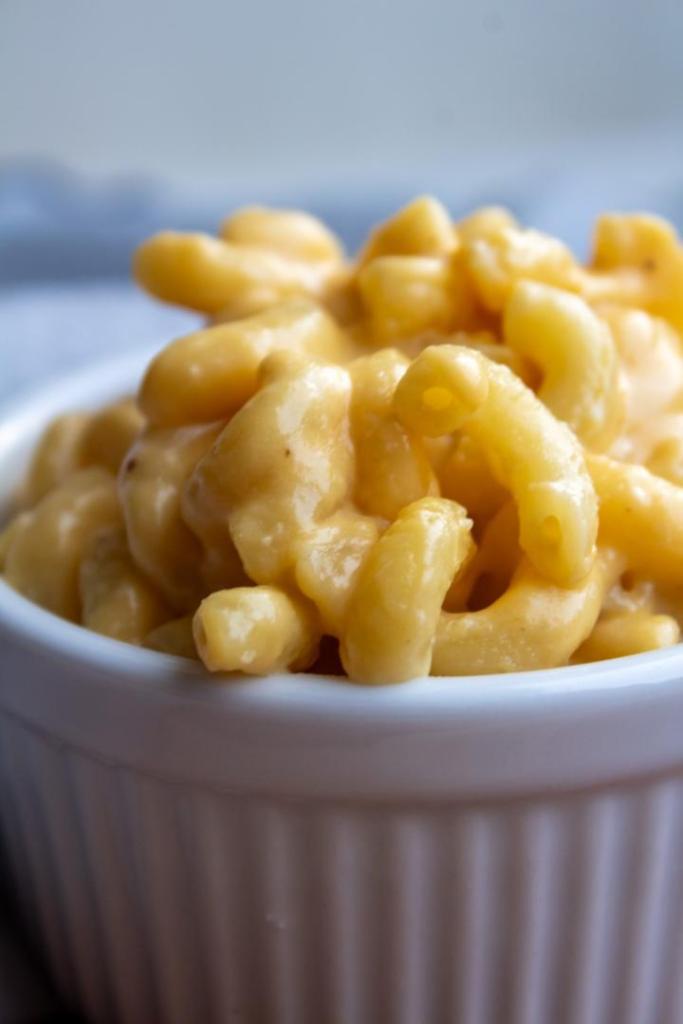 Creamy, cheesy macaroni and cheese is shown up close in a ramekin.