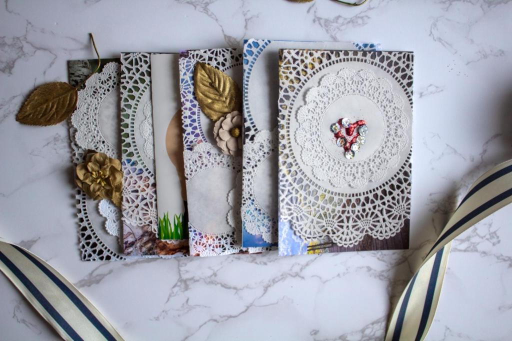 Homemade Valentine's Day cards are lined up in a row with gold leaves, faux flowers, and ribbon.