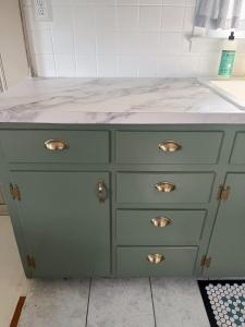 Lower base cabinets shine in new color after being painted.