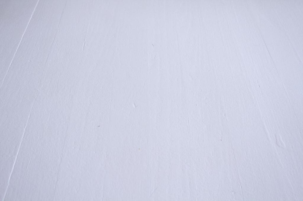 A freshly painted floor boasts a bright white color.