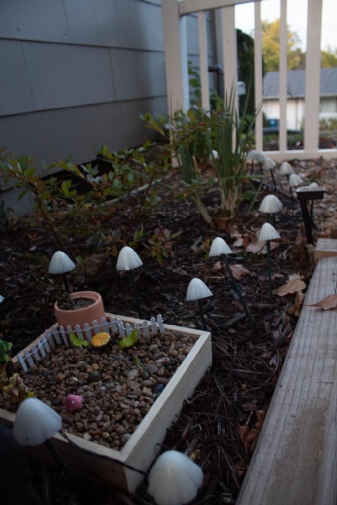 A spot is made for an outside fairy garden along a patio bed.