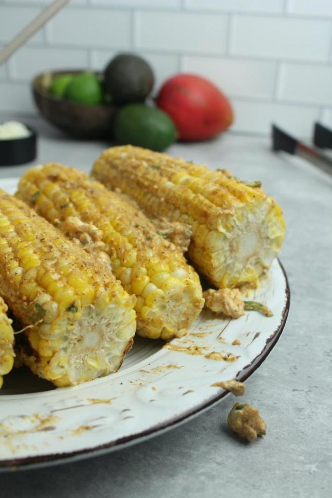 Corn has been basted in a delicious mayo sauce for making Elote.