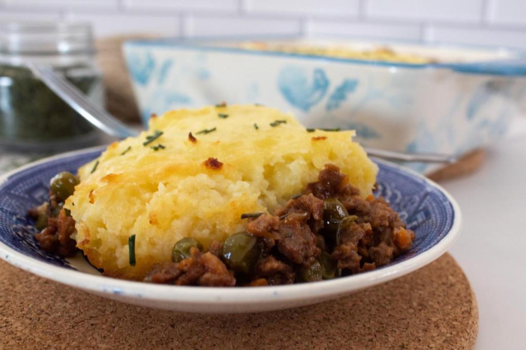 Shepherd's pie has an entire spread laid out with chives, linens, and the cottage pie itself.