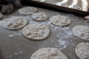 Salt dough ornaments are on a cookie sheet.
