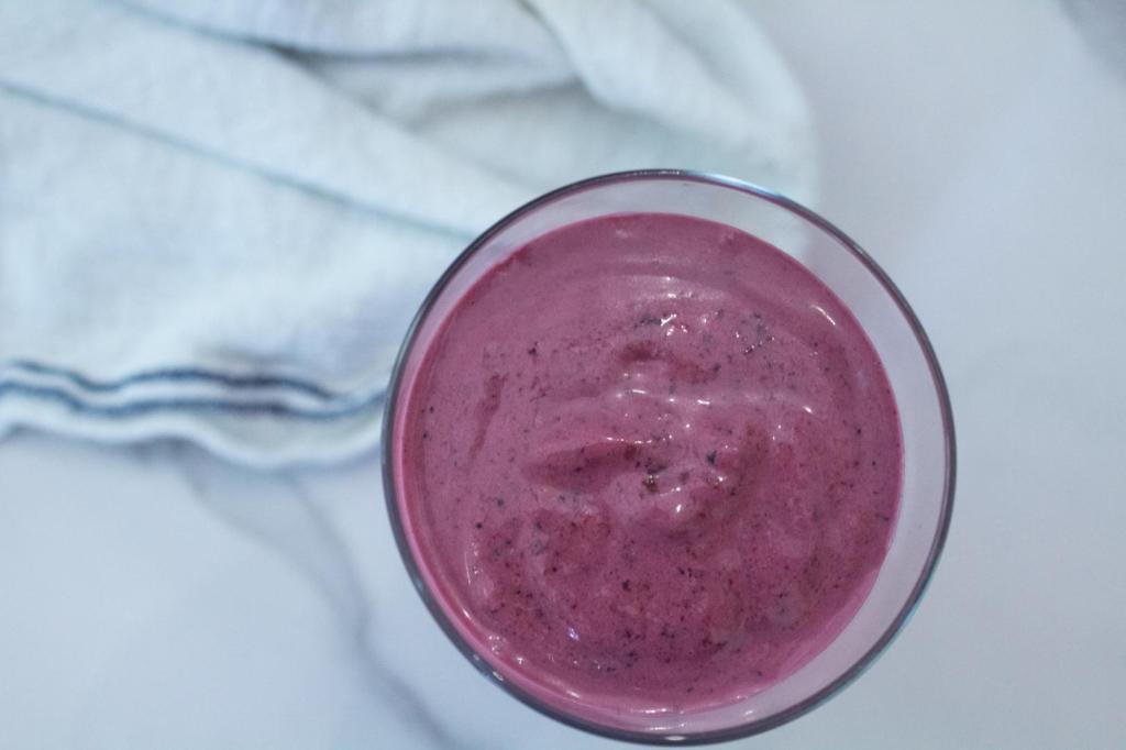 A mixed berry smoothie is blended up and served.