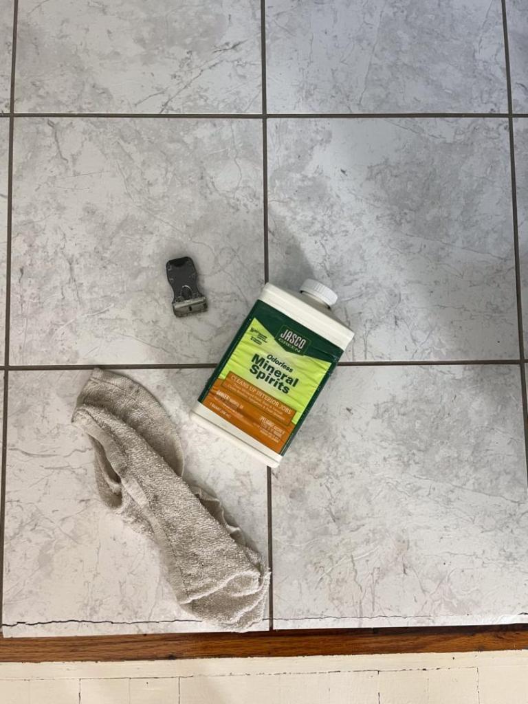 Mineral spirits are shown on a floor.