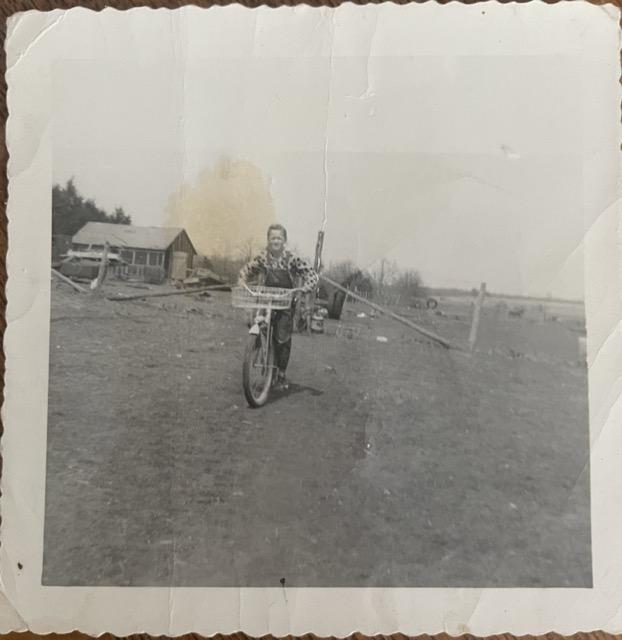 A school-age child plays on his bike on a farm in Missouri during the early 1950s.