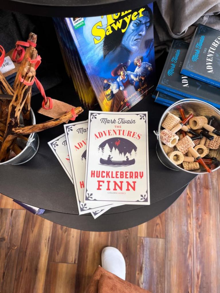 Mark Twain items line an entire table in a merchant shop.