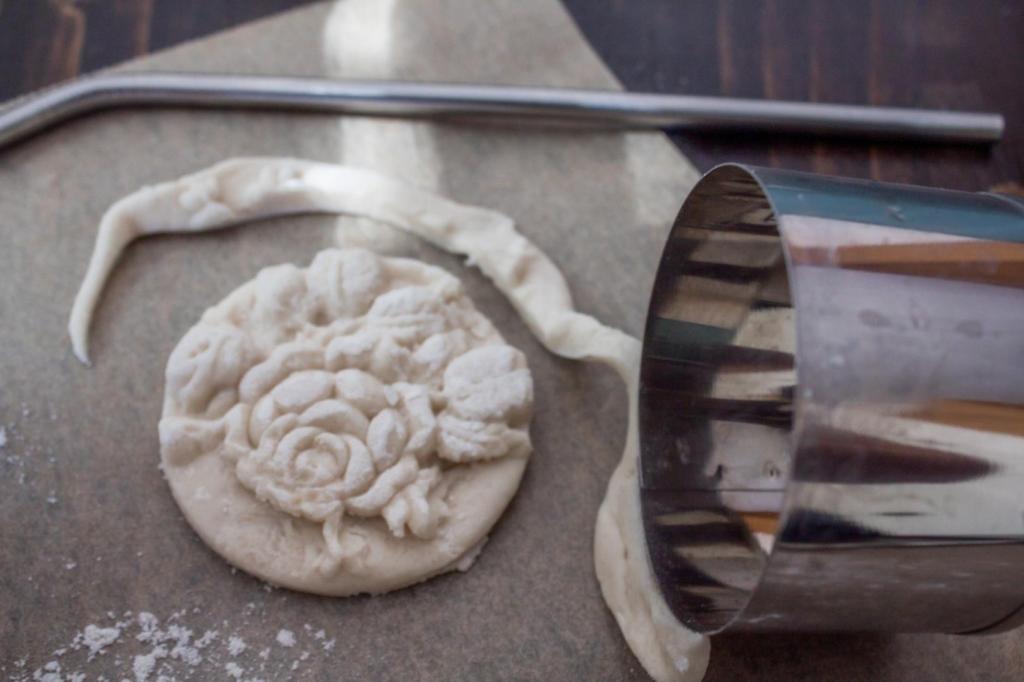Edges are trimmed from a salt dough ornament.