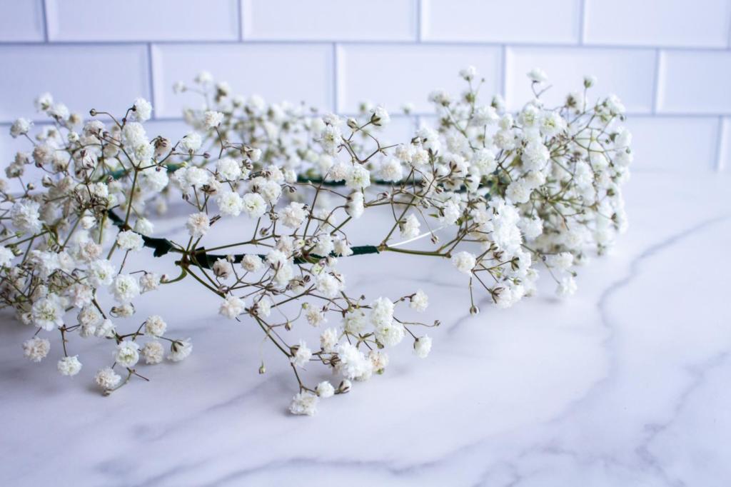 A flower crown is complete and is shown off up close with details of the baby's breath secured to it.