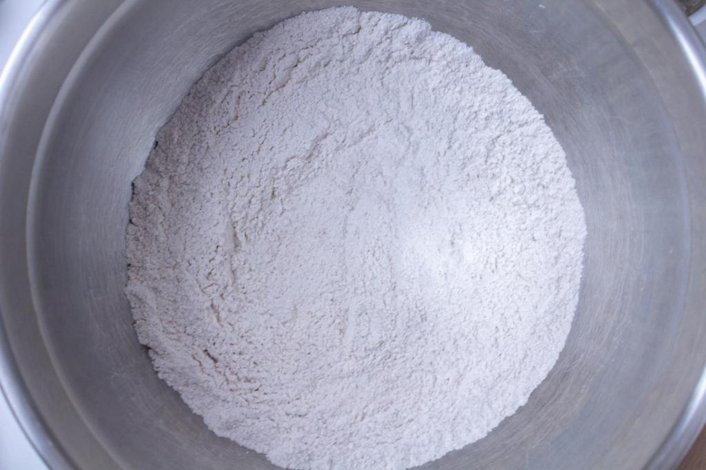 Dry ingredients have been combined in a metal mixing bowl.