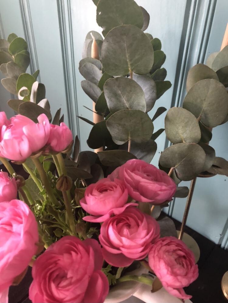 Flowers are placed on a dining room table.