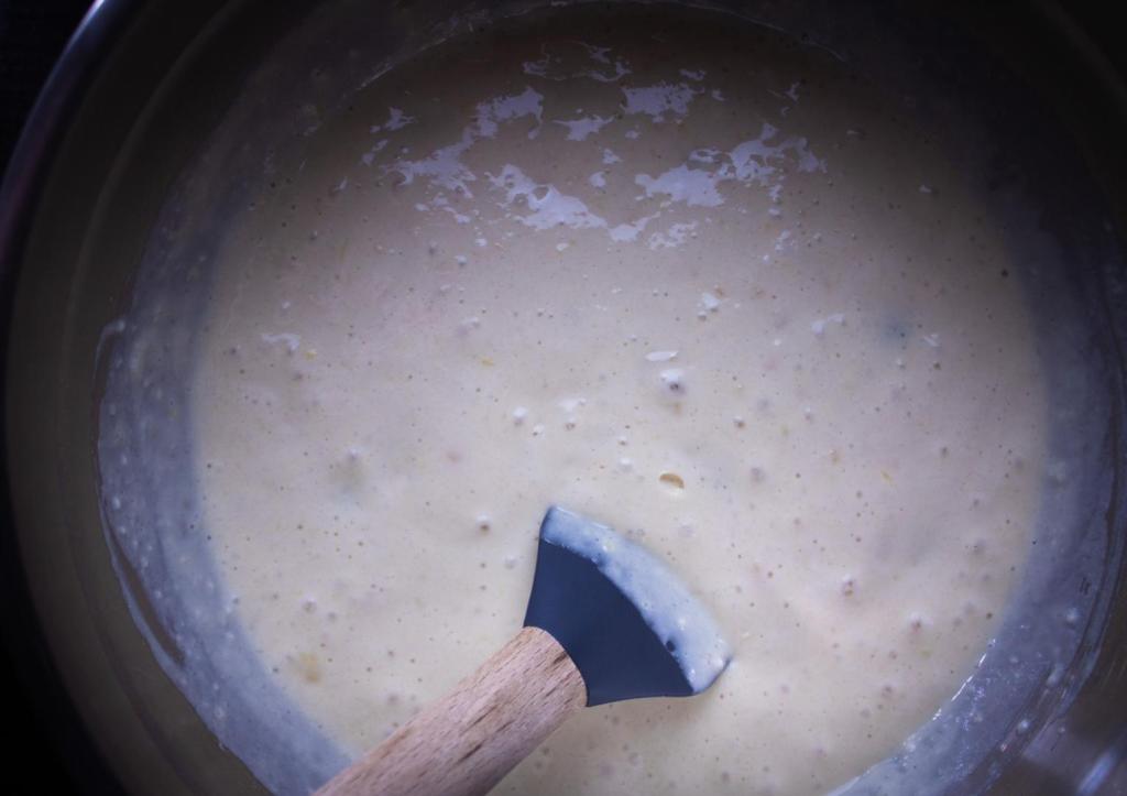 A thick, slightly bubbly pancake batter is mixed up.