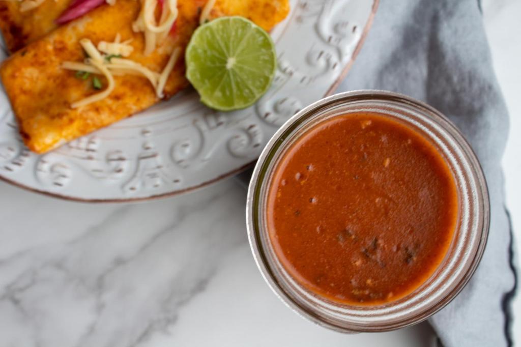 Red enchilada sauce is added to enchiladas.