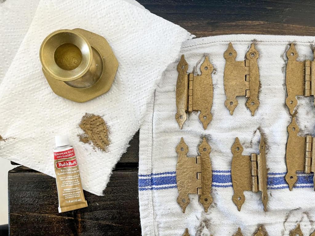 Rub n Buff European Gold is shown next to newly refinished cabinet hardware pieces.