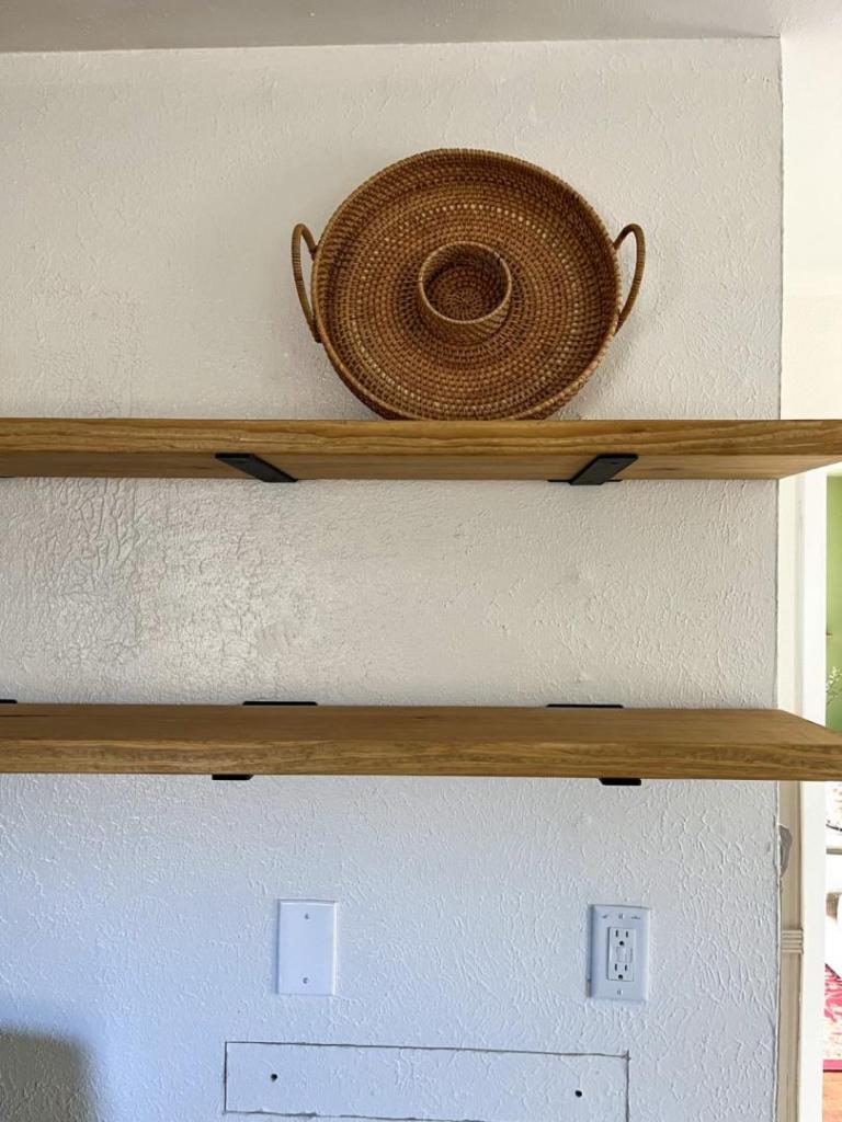 A second shelf is secured and has its first item, a basket, added to it.